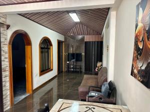 a living room with a couch and a table at Hospedaje Nacho y Ale 1, con 3 AC, Paso Canoas, CR in Canoas