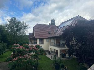 a house with a roof with solar panels on it at Gîte Grewis in La Wantzenau