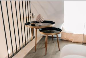a small table and a stool in a room at NICOLAUS SUITE Wellness Experience in Bari Palese