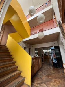 a staircase in a building with a yellow wall at Hotel Nativo in Santiago