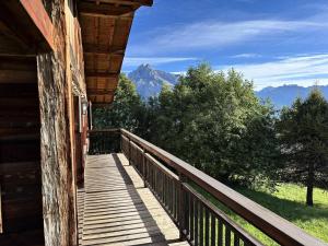 a porch of a cabin with a view of a mountain at Chalet Lombard - CHALET 10 PERSONNES MAE-2711 in Combloux
