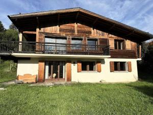 a large wooden house with a balcony on top at Chalet Lombard - CHALET 10 PERSONNES MAE-2711 in Combloux