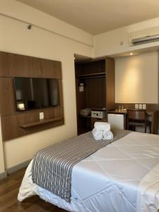 Cama ou camas em um quarto em Hotel Vivenzo Savassi Belo Horizonte