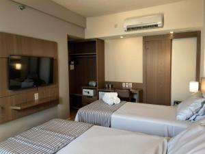 Cama ou camas em um quarto em Hotel Vivenzo Savassi Belo Horizonte