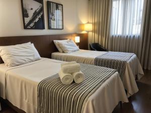 Cama ou camas em um quarto em Hotel Vivenzo Savassi Belo Horizonte