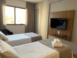 Cama ou camas em um quarto em Hotel Vivenzo Savassi Belo Horizonte
