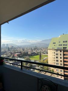 a view of a city from a balcony at Dept Hermosa Vista, Las Condes in Santiago