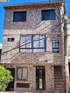 a brick building with glass windows on it at MODERNO y AMPLIO APARTAMENTO in Medellín
