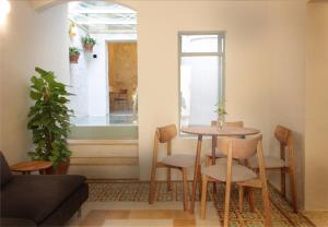 a table and chairs in a room with a window at Tonina in Rabat