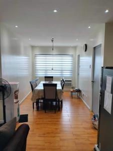 a dining room with a table and chairs and a couch at Seawind condo in Davao City
