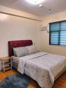 a bedroom with a large bed and a window at Seawind condo in Davao City