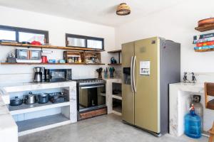 a kitchen with a stainless steel refrigerator and counters at Casa Arrecife Tortuga, Fast Internet, private Cozy room in La Ventana