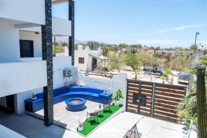 a view of a pool from the balcony of a house at Casa Arrecife Tortuga, Fast Internet, private Cozy room in La Ventana