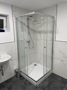 a shower stall in a bathroom with a sink at Ferien Wohnung Kassel Cassel Zentral in Kassel