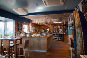 a bar in a restaurant with tables and chairs at Motor Yacht Sea Wolf in Lymington