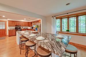 a kitchen with a large island with bar stools at Red River Gorge Cabin Hike and Relax! in Rogers