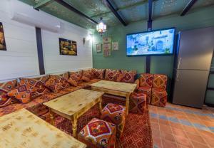 a room with a couch and tables and a tv at Iguana Azul in Chefchaouen +53 photos