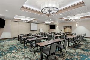 a conference room with tables and chairs and a podium at Best Western Seaway Inn in Gulfport