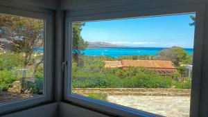a window with a view of the ocean at Villa Haass in Stintino