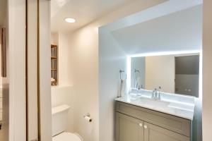 a bathroom with a sink and a toilet and a mirror at 5 Mi to Mall of America South Minneapolis Home in Minneapolis +16 photos