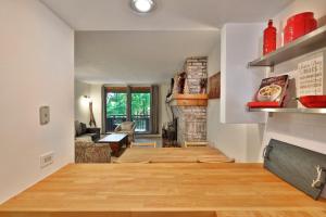 a living room with a fireplace and wooden floors at Sunrise Timberline M1- Cozy 2 BR Ski On Ski Off Condo in Killington