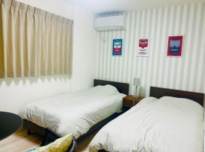 Postel nebo postele na pokoji v ubytování 嵐翁居らんおうきょ Ranohkyo