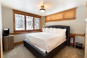 a bedroom with a bed and a window at 671 Elk Circle by Summit County Mountain Retreats in Keystone