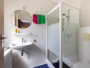 a white bathroom with a sink and a shower at Zonnehoek in Exloo +50 photos