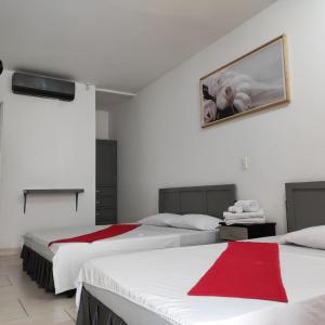 Postel nebo postele na pokoji v ubytování Hotel Gueicer Cucuta