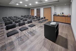 a conference room with a row of chairs and a podium at City Express by Marriott Tijuana Insurgentes in Tijuana