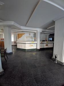 an empty room with columns in a building at Golf Hotel in Hurghada