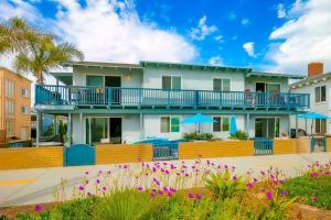 a house with a balcony with purple flowers at Oceanfront Condo in Newport Beach with Private Balcony and Perfect Location by the Pier in Newport Beach