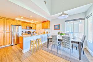 a kitchen with a table and chairs and a kitchen with a refrigerator at Condo in Newport Beach with Private Balcony and Ideal Location by the Pier in Newport Beach