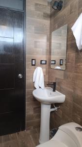 a bathroom with a sink and a toilet and a mirror at APARMENTS Av LA PAZ in Arequipa