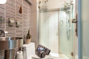 a bathroom with a shower and a sink and a toilet at iDesign Loft at Old San Juan in San Juan