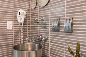 a kitchen with a sink and a phone on the wall at iDesign Loft at Old San Juan in San Juan