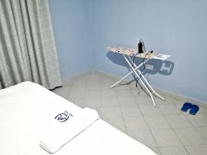 a room with a table with a laptop on it at NM Luxury Homes in Nakuru