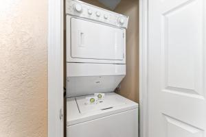 a white washer and dryer in a small kitchen at Serenity Now in Branson
