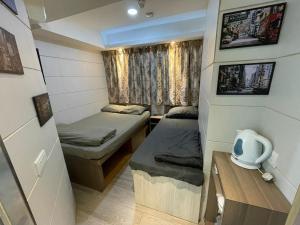 Ένα ή περισσότερα κρεβάτια σε δωμάτιο στο 香港榆臨賓館 Yulam Guesthouse