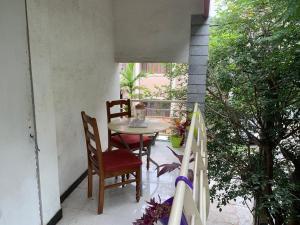 a patio with a table and chairs on a balcony at Abids Inn Homestay in Bangalore