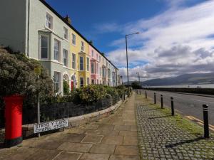 a row of houses on the side of a street at Lluest in Beaumaris