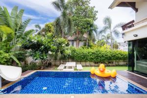 a swimming pool with a rubber duck toy in the water at Amazing Natcha villa in Pattaya