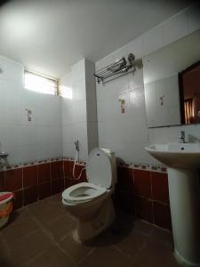 a bathroom with a toilet and a sink at Abids Inn Homestay in Bangalore +19 photos
