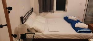 a small bed in a room with a window at Πλάτανος Στούντιο ΙΙ Platanos studio II in Mytilene