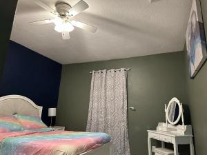 a bedroom with a bed and a ceiling fan at Dream home in Port Richey