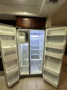 an empty refrigerator with its doors open in a kitchen at Dream home in Port Richey