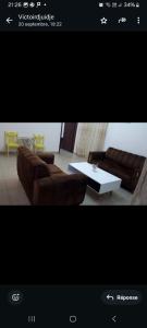 a living room with a couch and a coffee table at Chez Jo Trois in Simbok