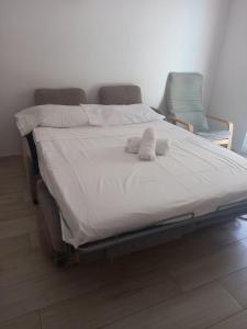 a bed with two white towels on top of it at Apartalux Centralmar Centro in Benidorm