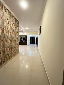 an empty hallway with a wall with a tile floor at Dream Inn Guest House Islamabad in Islamabad