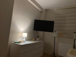 a living room with a tv on a wall at Urban Apartman-privatan parking- in Kraljevo